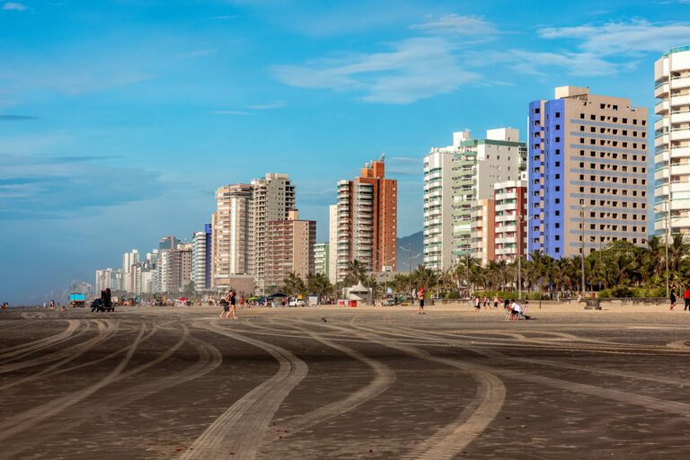 Vibrant urban beachfront with high-rise buildings under a clear blue sky, perfect for urban retreat.