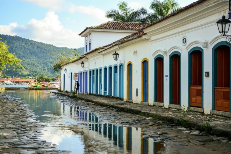 Colorful historic buildings reflected in a cobblestone street in Paraty, Brazil.