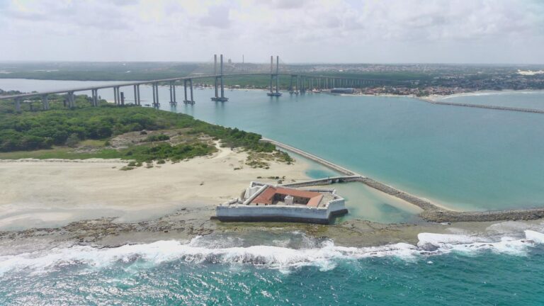A stunning aerial view of the Newton Navarro Bridge and surrounding coastline in Natal, Brazil, showcasing beautiful summer scenery.
