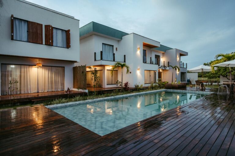 Luxurious modern villa in Bahia, Brazil with a serene poolside view during twilight.