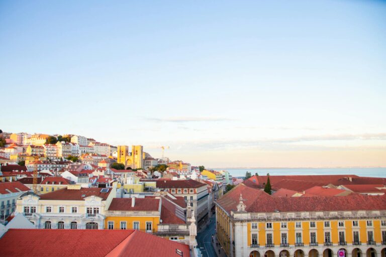Scenery of modern residential district houses roofs located in Lisbon in early evening under clear blue sky