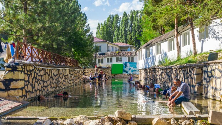 People enjoying the therapeutic thermal springs in Sivas, Turkey, surrounded by natural beauty.